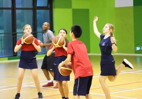 Pupils play basketball at King's College School Hangzhou