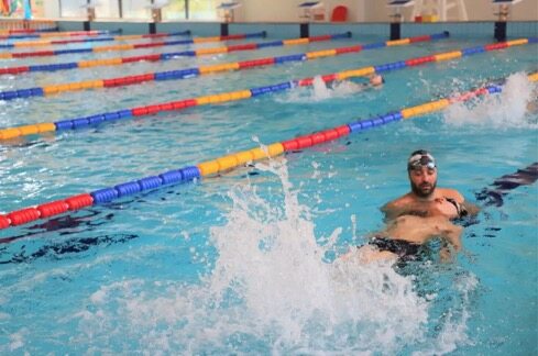 A King's College School Hangzhou pupil receives swimming instruction from a teacher