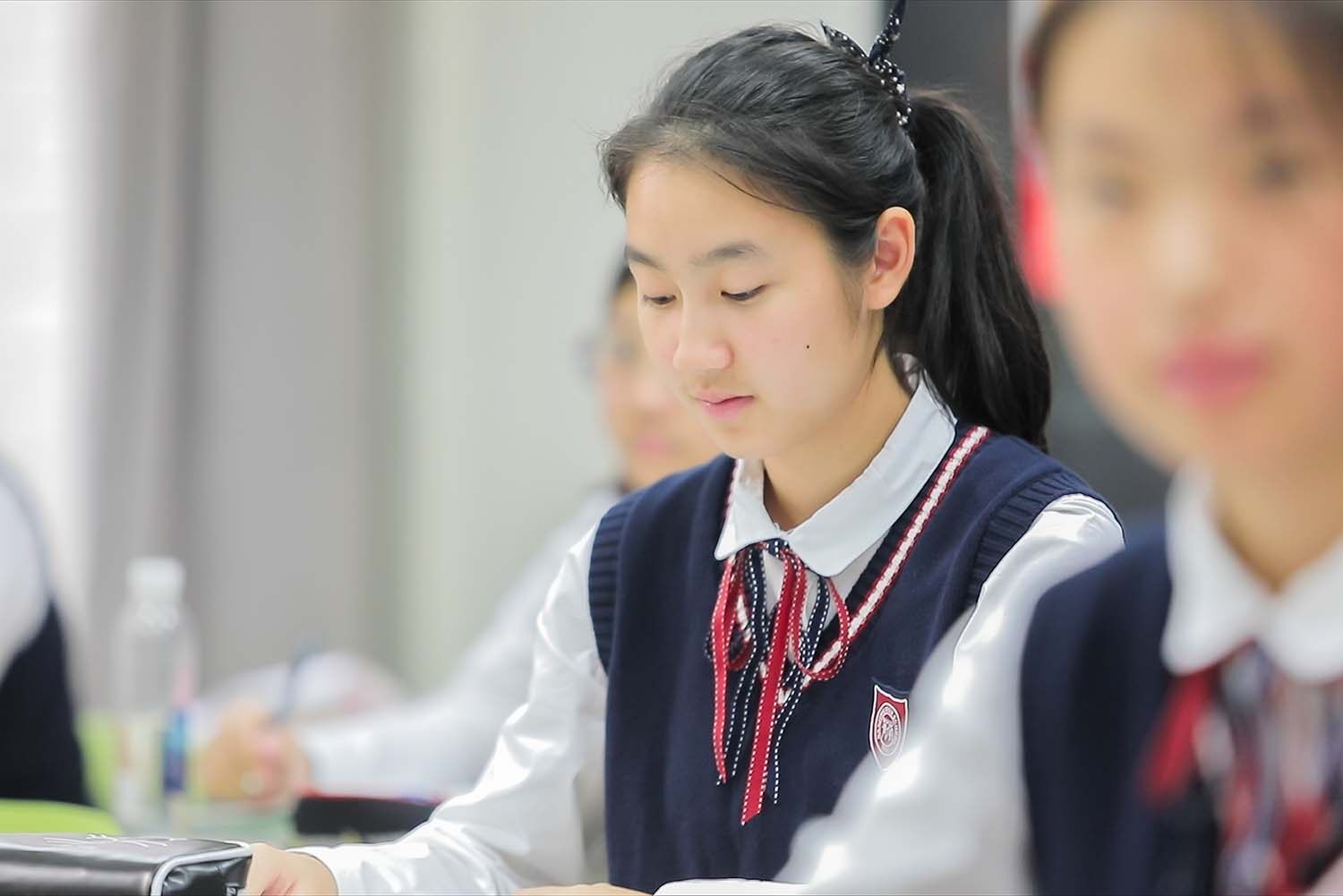 A Chinese student concentrates on her work in a school in China